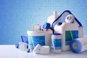 Chemical cleaning products for pool with blue mosaic background overview